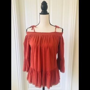 Off shoulder rust blouse with tie straps.